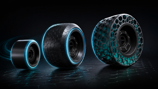 Three Journ-E electric skateboard wheel sizes side by side on a dark reflective surface, shown as a direct size comparison