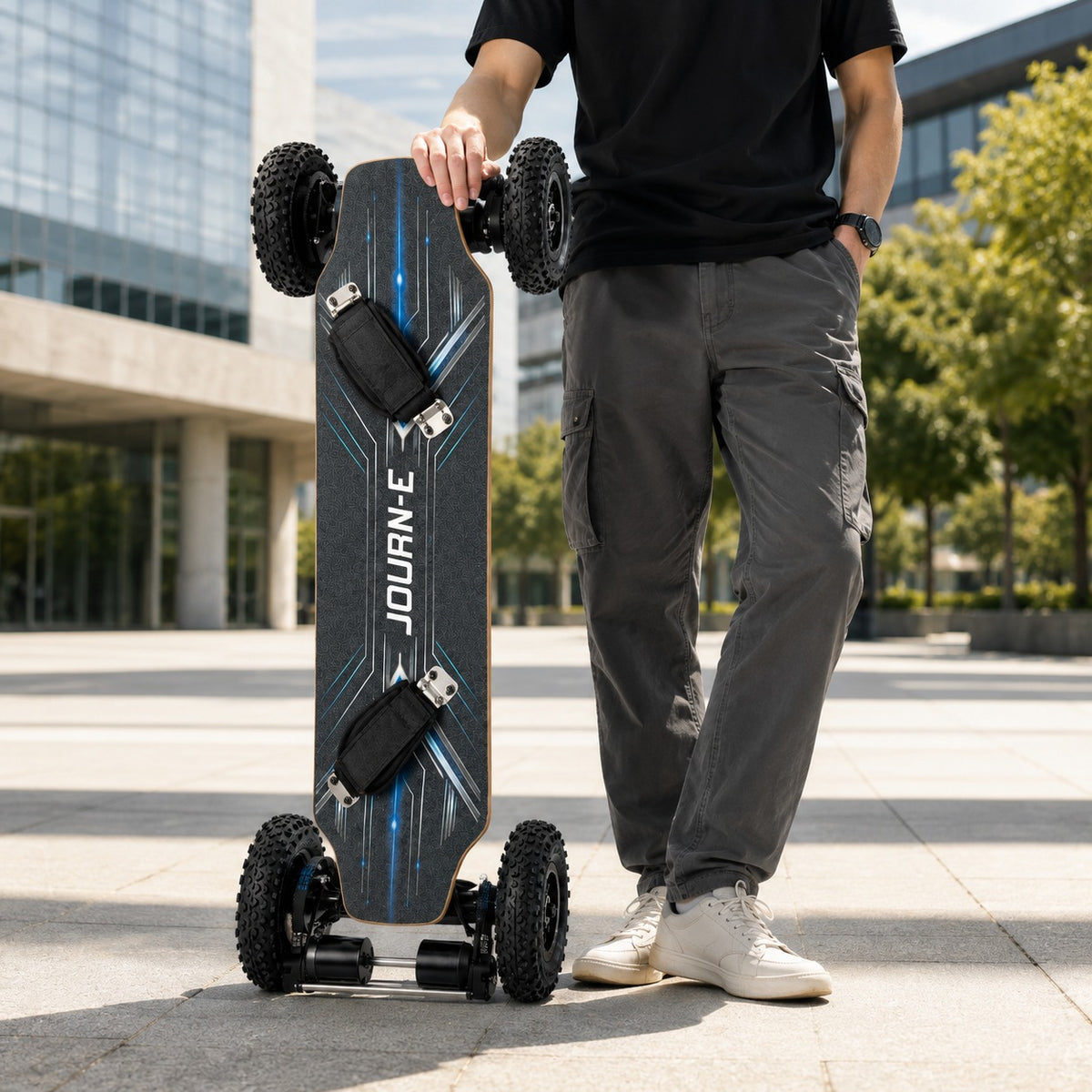 Journ-E Apex all-terrain electric skateboard being ridden on rough ground, showing the off-road tyres in use