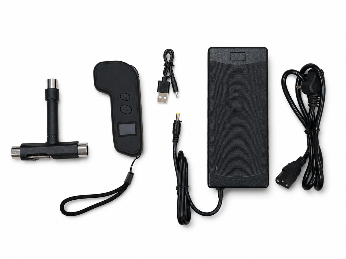 A black handheld electronic tool kit laid out on a white background, including a T-shaped handle with metal tips, a handheld controller with buttons and wrist strap, a USB charging cable, a rectangular power adapter, and a coiled power cord.